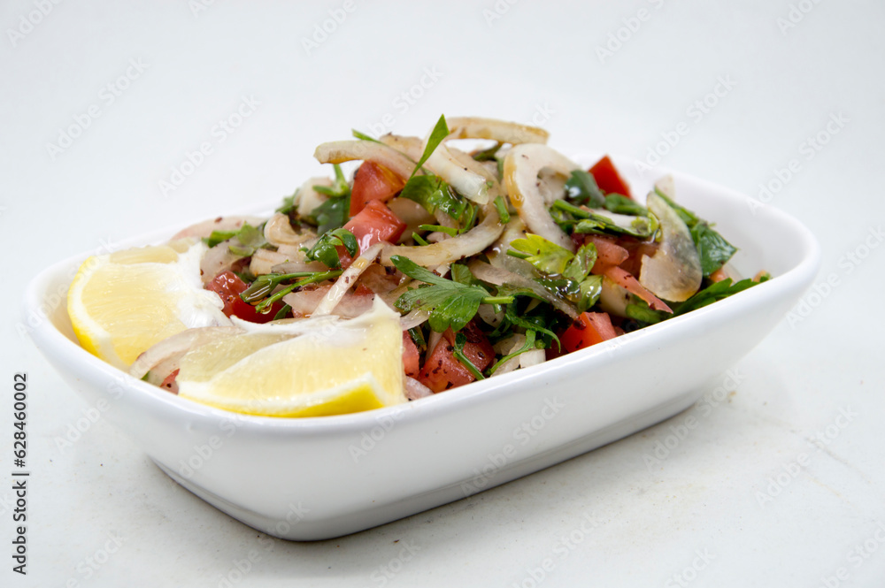 Salad made with tomatoes, onions, parsley, lemon and olive oil Salad made with tomatoes, onions, parsley, lemon and olive oil