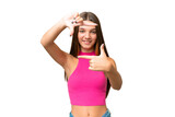 Teenager caucasian girl over isolated background focusing face. Framing symbol