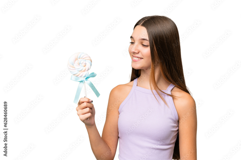 Teenager caucasian girl holding a lollipop over isolated background with happy expression Teenager caucasian girl holding a lollipop over isolated background with happy expression