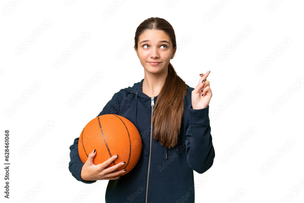 Teenager caucasian girl playing basketball over isolated background with fingers crossing and wishing the best Teenager caucasian girl playing basketball over isolated background with fingers crossing and wishing the best
