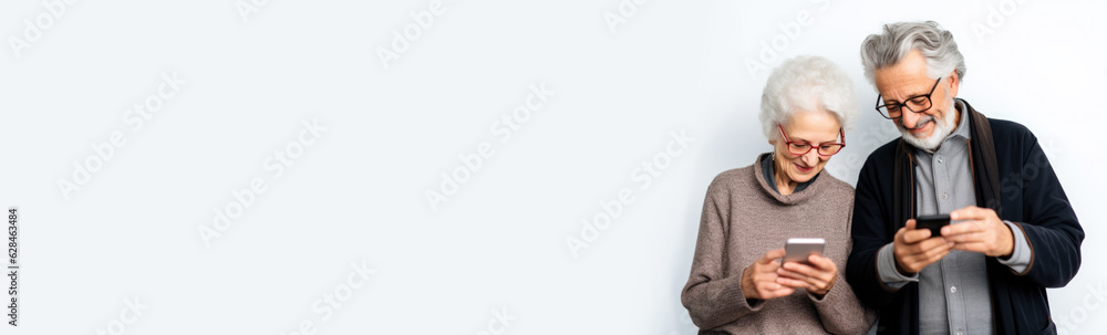 Elderly couple looking at smart phones. Seniors using technology. Banner with space for text. Elderly couple looking at smart phones. Seniors using technology. Banner with space for text.