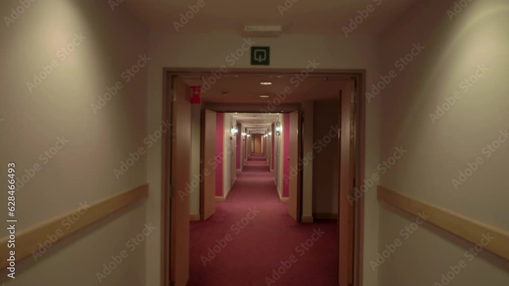 Walking along an ominous passage in a spooky, deserted hotel Walking along an ominous passage in a spooky, deserted hotel