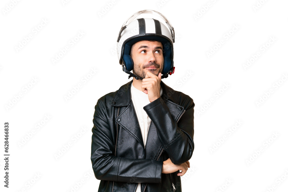 Young caucasian man with a motorcycle helmet over isolated chroma key background having doubts and thinking Young caucasian man with a motorcycle helmet over isolated chroma key background having doubts and thinking