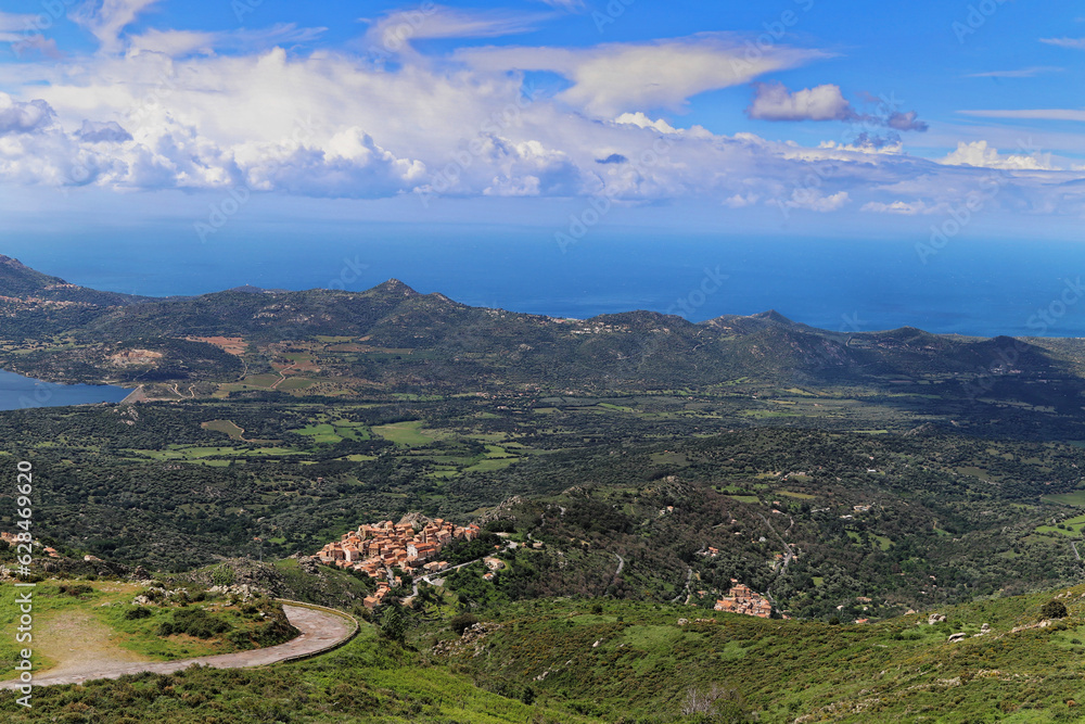 High angle  view  from Col de la Bataille of Speloncato, typical north Corsican  village in Balagne, with plaine du Reginu and Ile Rousse and sea in the Background