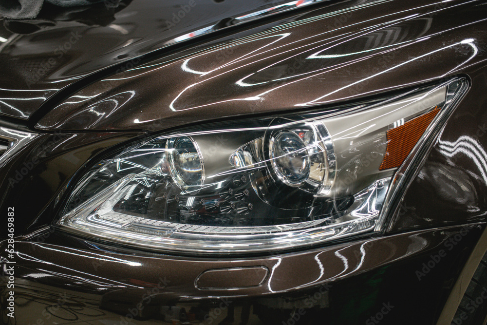 Fototapeta premium Modern Car exterior details.Headlight of a modern sport car close-up. 