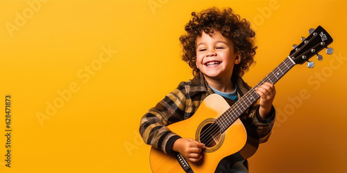 Print op canvas Joyful child playing guitar isolated on flat orange background with copy space