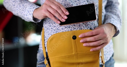 Wallpaper Mural Woman hand takes out smartphone from bag. Mobile phone use Torontodigital.ca