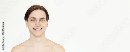 Closeup male portrait. Cute smiling young adult man model on white background