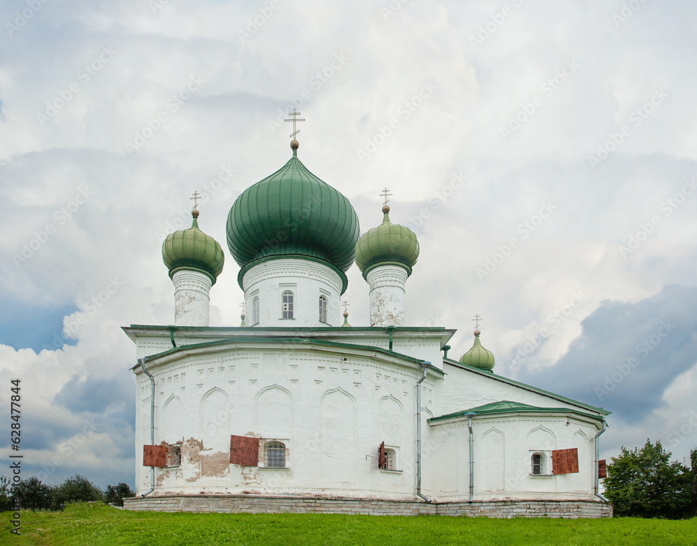 White church with green domes in old Ladoga, Russia. Old Eastern Orthodox church