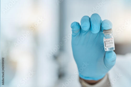 Vaccine, medicine and hand of a doctor with gloves for virus protection, health care and cure in hospital. Person with a pharmaceutical product, vial or container for treatment or prevention space