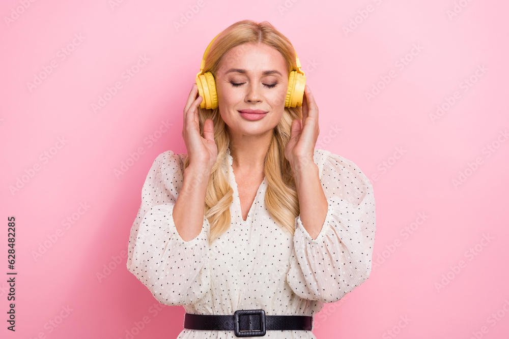 Chill closed eyes beautiful young woman wear trendy dress summer harmony time listen music headphones isolated on pink color background Chill closed eyes beautiful young woman wear trendy dress summer harmony time listen music headphones isolated on pink color background