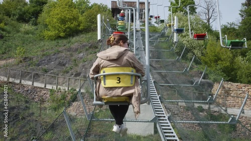 Female Tourist Riding A Chairlift At Prague Zoological Garden In The Czech Republic. Slow Motion photo