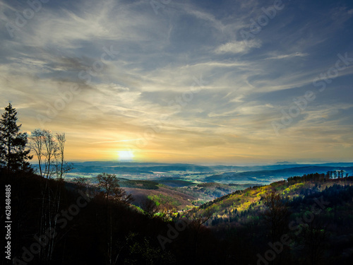 Beautiful shot of a sunset over small hills with light and shadow play © D. Schweitzer