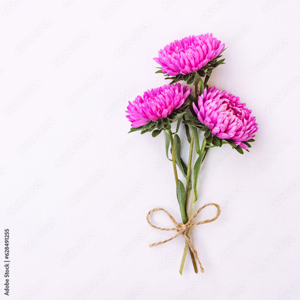 Fototapeta premium Bright cute bouquet of asters isolated on white background