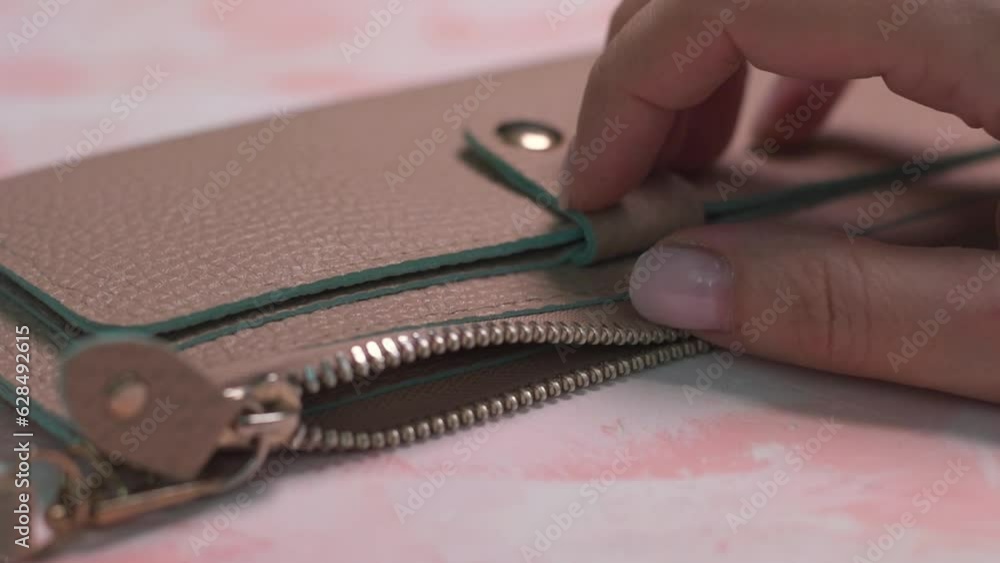 woman opens an empty wallet. there is no money in the wallet.