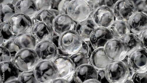 Colorless hydrogel balls closeup. Hydrogel balls moving, macro shot. photo