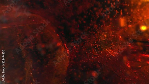 Bubbles and Ice Cubes in a Glass of Cola or Lemonade