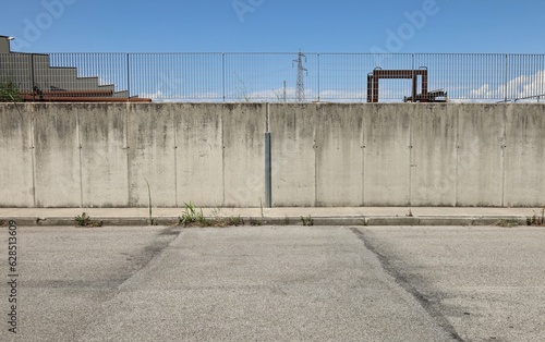 Wallpaper Mural Surrounding wall made of concrete blocks with railing on top in the industrial area. Sidewalk and road in front. Background for copy space. Torontodigital.ca