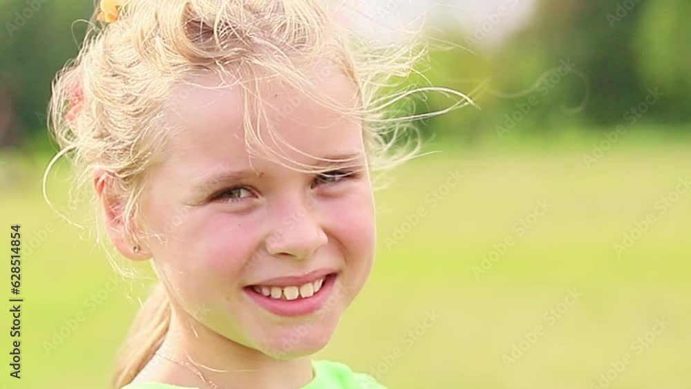 Little girl having fun resting in the city park, look at the camera close-up Little girl having fun resting in the city park, look at the camera close-up