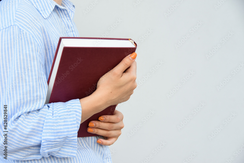 Young woman holding book in her hands , with space for text Young woman holding book in her hands , with space for text