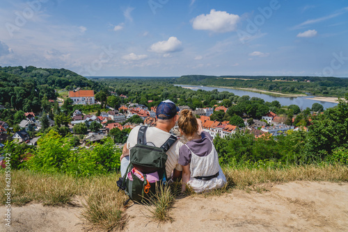 Father and daughter looking at the city skyline on a sunny summer day. Kazimierz Dolny.

 photo