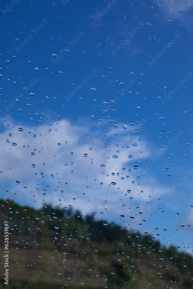 Rain drops window glass. Rainy day sky view through window