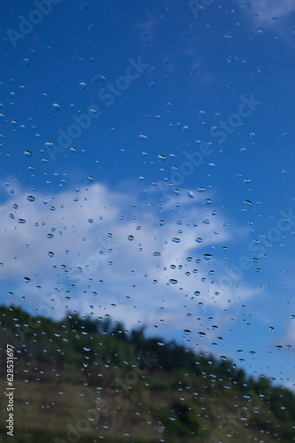 Rain drops window glass. Rainy day sky view through window