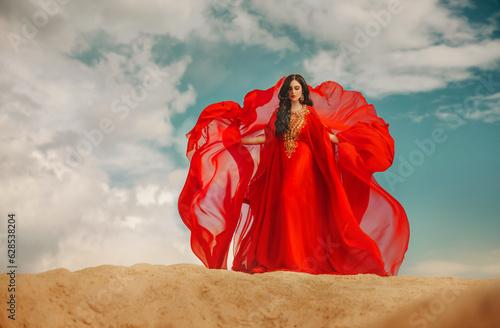 Valokuva arabic sexy woman standing on sand desert dunes blue sky