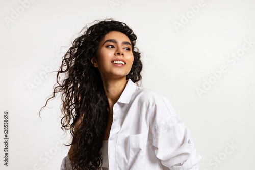 Obraz na plátne Modern Asian beautiful girl in white shirt with waving curly long hair