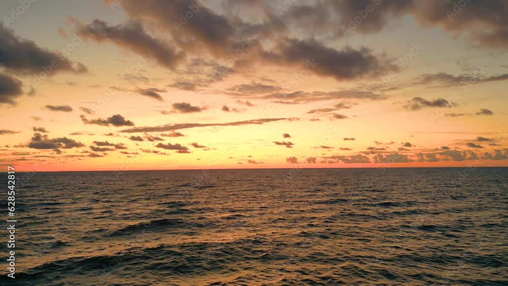 Sea scenery. Drone view. Sunset horizon. Nature beauty. Water landscape. Blue ocean waves relaxing motion on red orange sun light skyline background aerial shot. Sea scenery. Drone view. Sunset horizon. Nature beauty. Water landscape. Blue ocean waves relaxing motion on red orange sun light skyline background aerial shot.