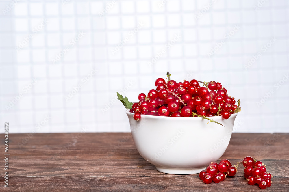 Red currant berries in a cup in the kitchen. Red currant berries in a cup in the kitchen.