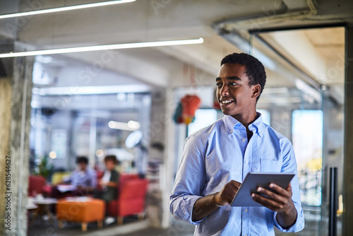 Young man using a digital tablet while working in a startup company office