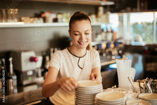 Young female barista working at a cafe