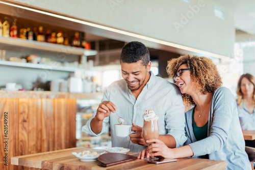 Young couple on a date in a cafe enjoying a cup of coffee