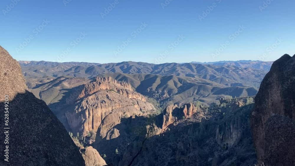 View of the dramatic red rock desert mountain landscape of Pinnacles National Park from the High Peaks trail. Taken early morning in summer - California, USA View of the dramatic red rock desert mountain landscape of Pinnacles National Park from the High Peaks trail. Taken early morning in summer - California, USA