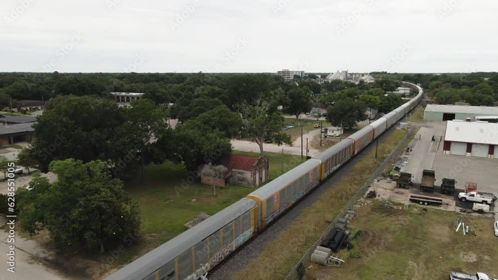 Backwards Tracking Aerial Of Freight Train Passing Through Small Texas Town Backwards Tracking Aerial Of Freight Train Passing Through Small Texas Town