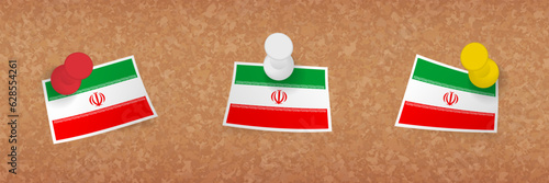 Iran flag pinned in cork board, three versions of Iran flag.
