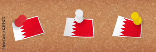 Bahrain flag pinned in cork board, three versions of Bahrain flag.