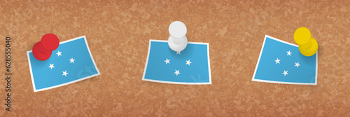 Micronesia flag pinned in cork board, three versions of Micronesia flag.