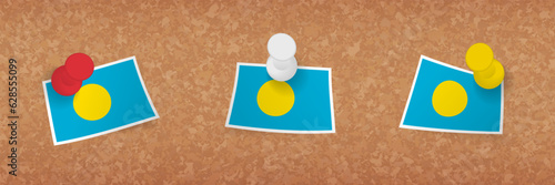 Palau flag pinned in cork board, three versions of Palau flag.
