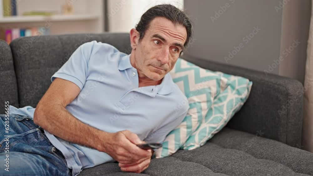 Middle age man doctor sending voice message at home