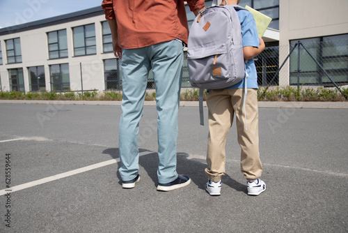 the father takes the boy to school. Parental care, return to school, education. first day at school