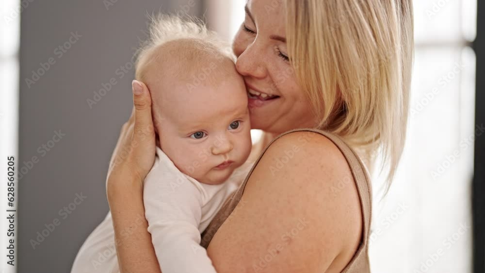 Mother and daughter hugging each other kissing at home Mother and daughter hugging each other kissing at home