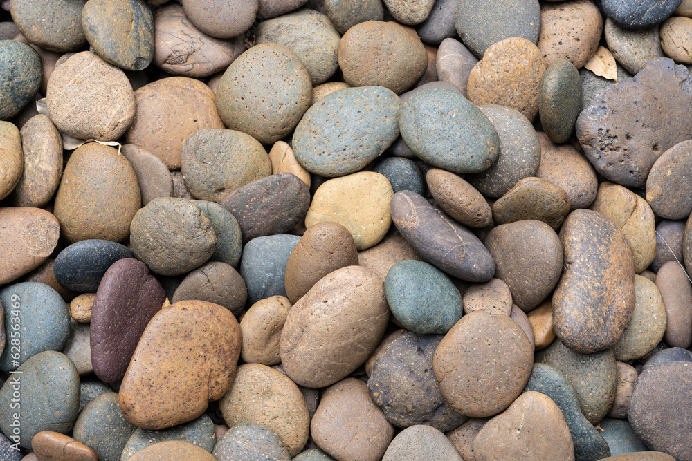 Round pebble stones background, rough texture of the stone, material for the garden decoration Round pebble stones background, rough texture of the stone, material for the garden decoration