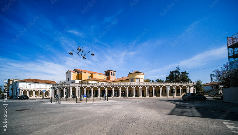 Fototapeta premium Tresigallo Italy church and portico - littorio style urban architecture