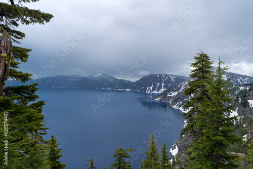 Looking over the rim into the Caldera of a volcano at Crater Lake National Park in Oregon on a stormy day.