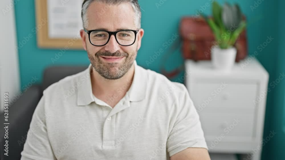 Grey-haired man business worker looking watch smiling at the office Grey-haired man business worker looking watch smiling at the office