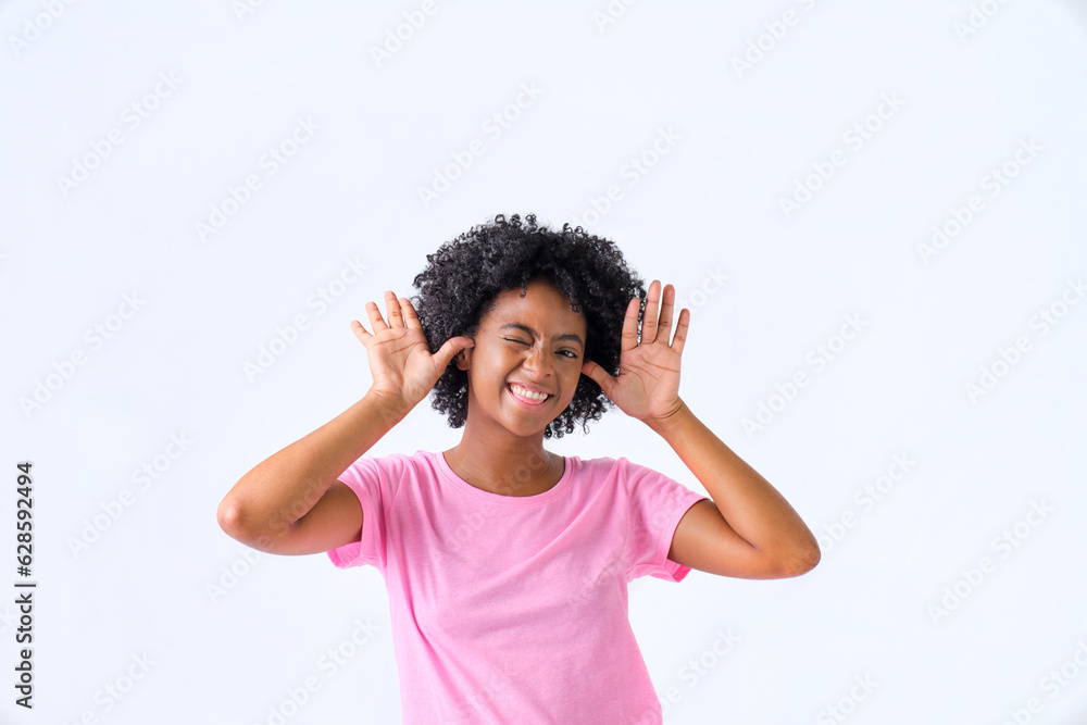 colombian girl with afro hair grimacing in pink t-shirt on white background colombian girl with afro hair grimacing in pink t-shirt on white background