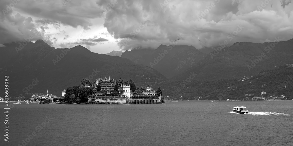Lago Maggiore summer panorama in Stresa with “Isola bella“ most famous of the “Borromean Islands“, a group of small islands in Italian part of the alpine lake. Black and white grey scale.