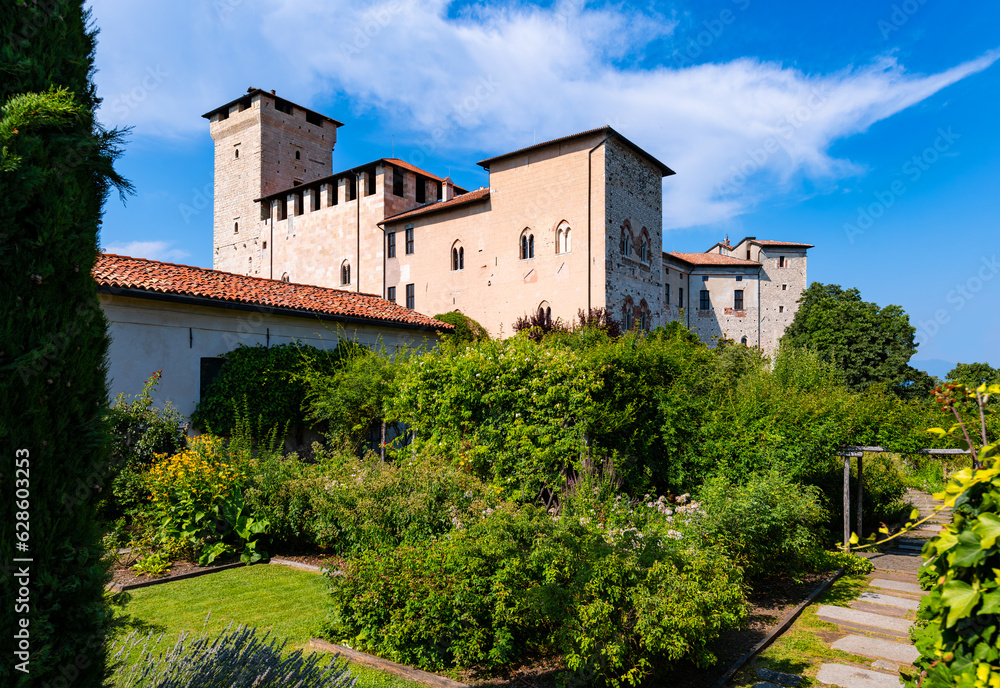 Garden of the historic castle in Angera. (“Rocca di Angera“) on a sunny summer day. The medieval fortress is a monument and tourist attraction on lake “Lago Maggiore“ near Milan, northern Italy.